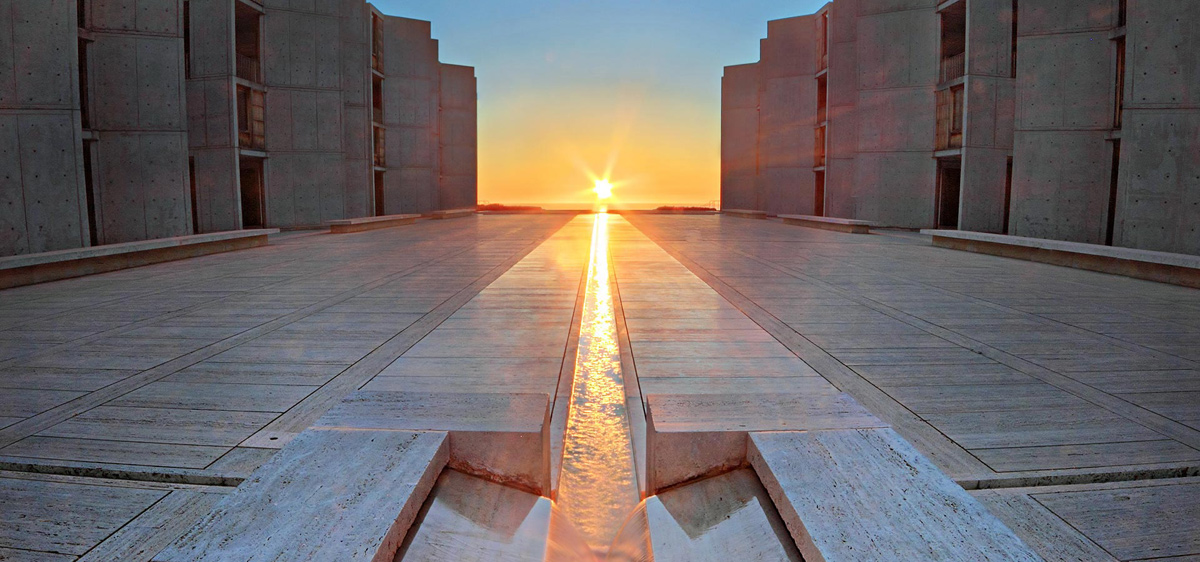 Slide 3 - view of Salk Institute unique architecture in San Diego with sunset in background